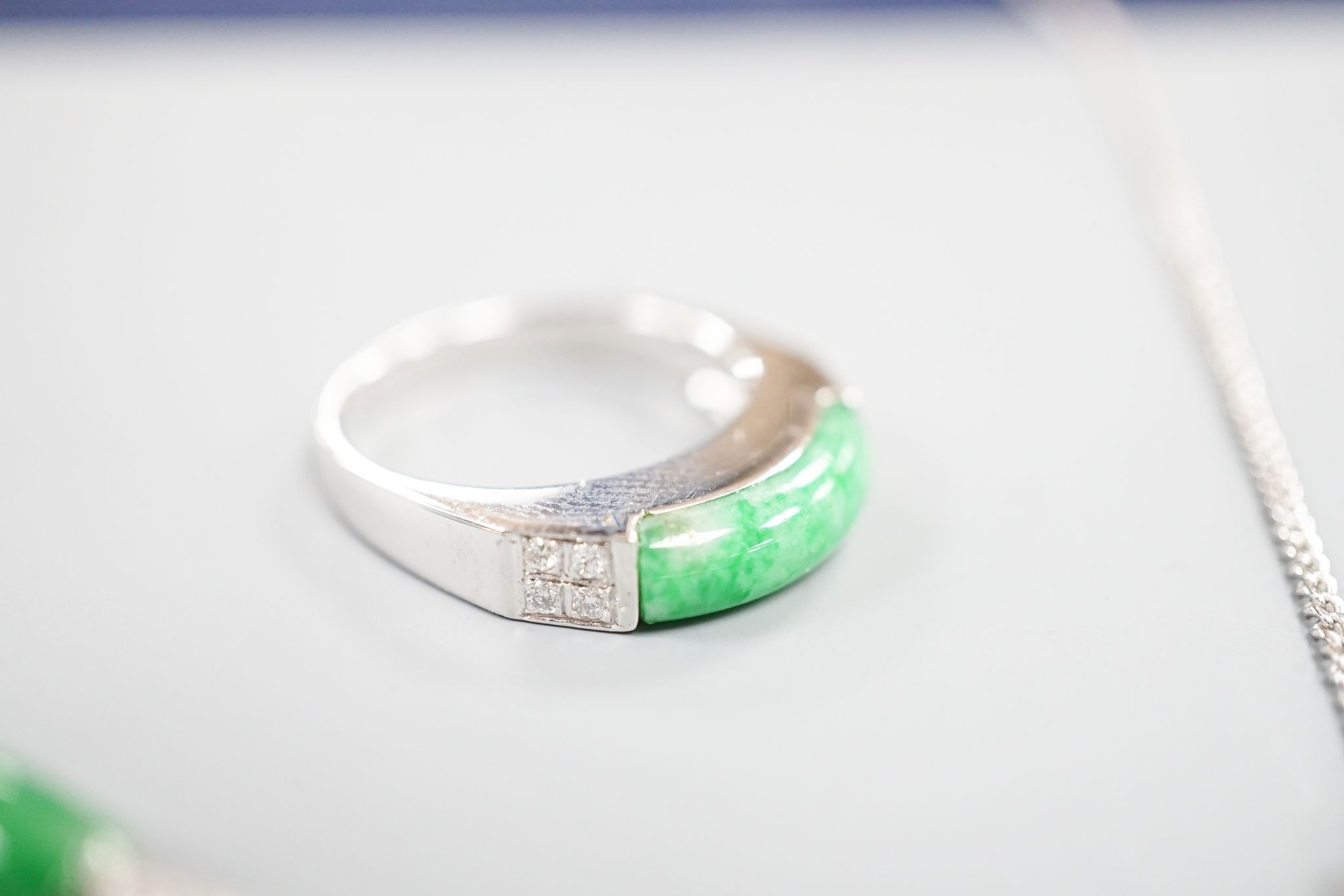 A modern white metal (stamped 850), jade and diamond cluster set bracelet, approx. 15.5cm, with a matching ring, size O and necklace, 38cm